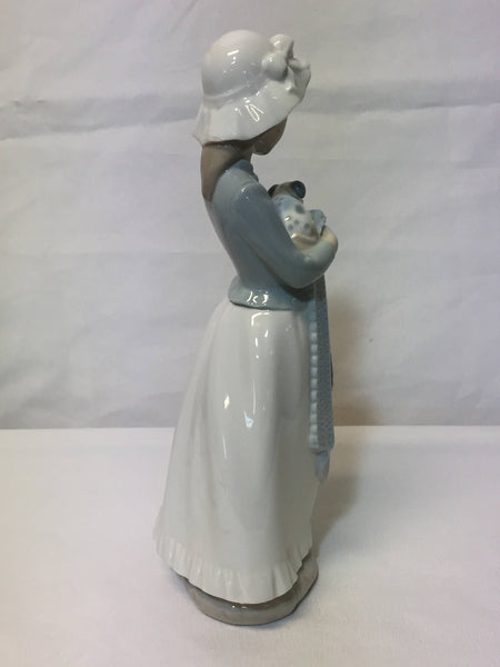 NAO/ LLADRO, porcelain figurine "Girl with a puppy dog." SOLD- SOLD - SOLD
