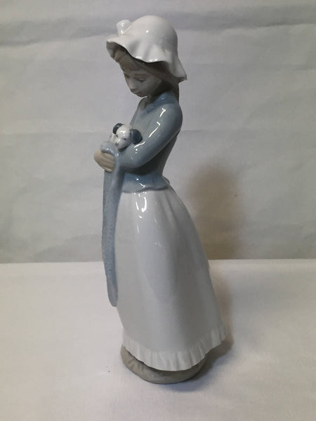 NAO/ LLADRO, porcelain figurine "Girl with a puppy dog." SOLD- SOLD - SOLD