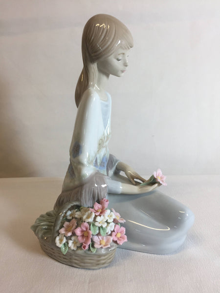 Lladro #7607 Flower Song 1988, girl sitting with flower basket 7" Tall